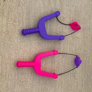 Water balloon hand slingshots